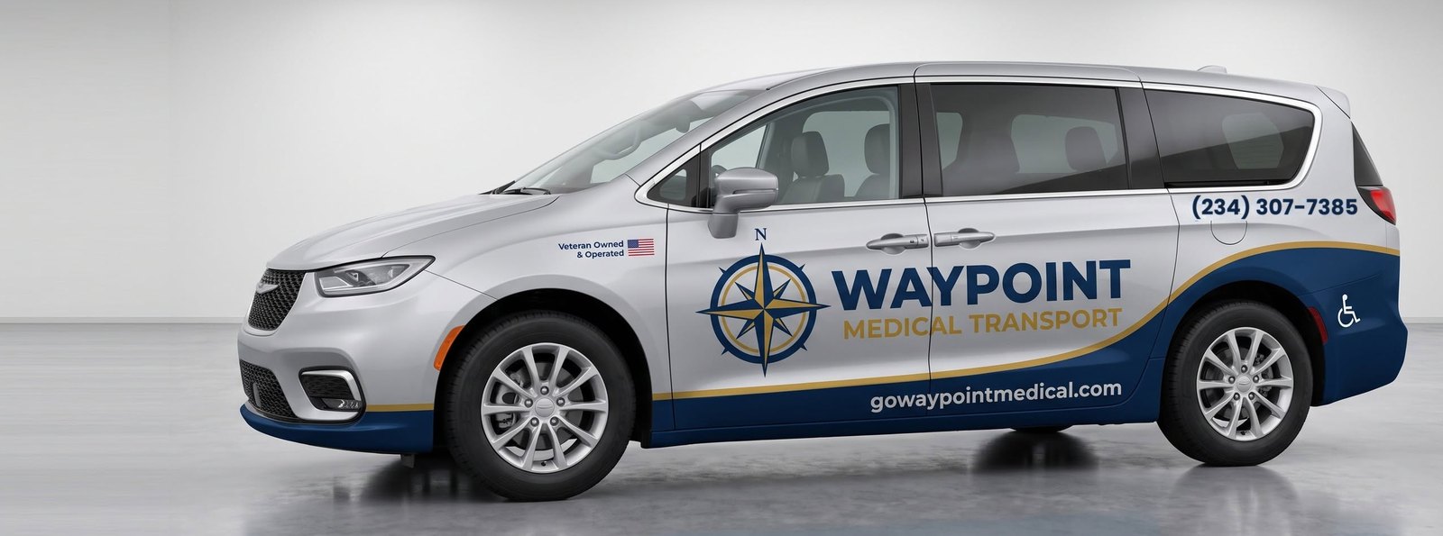 Waypoint Medical Transport wheelchair-accessible van in silver with the Waypoint compass livery, phone number and website on the side